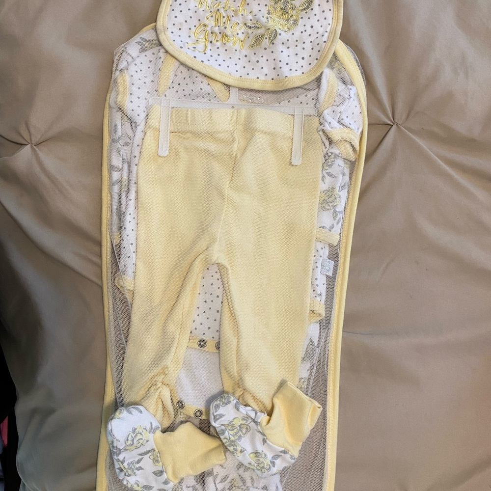 Garment bag containing matching layette set